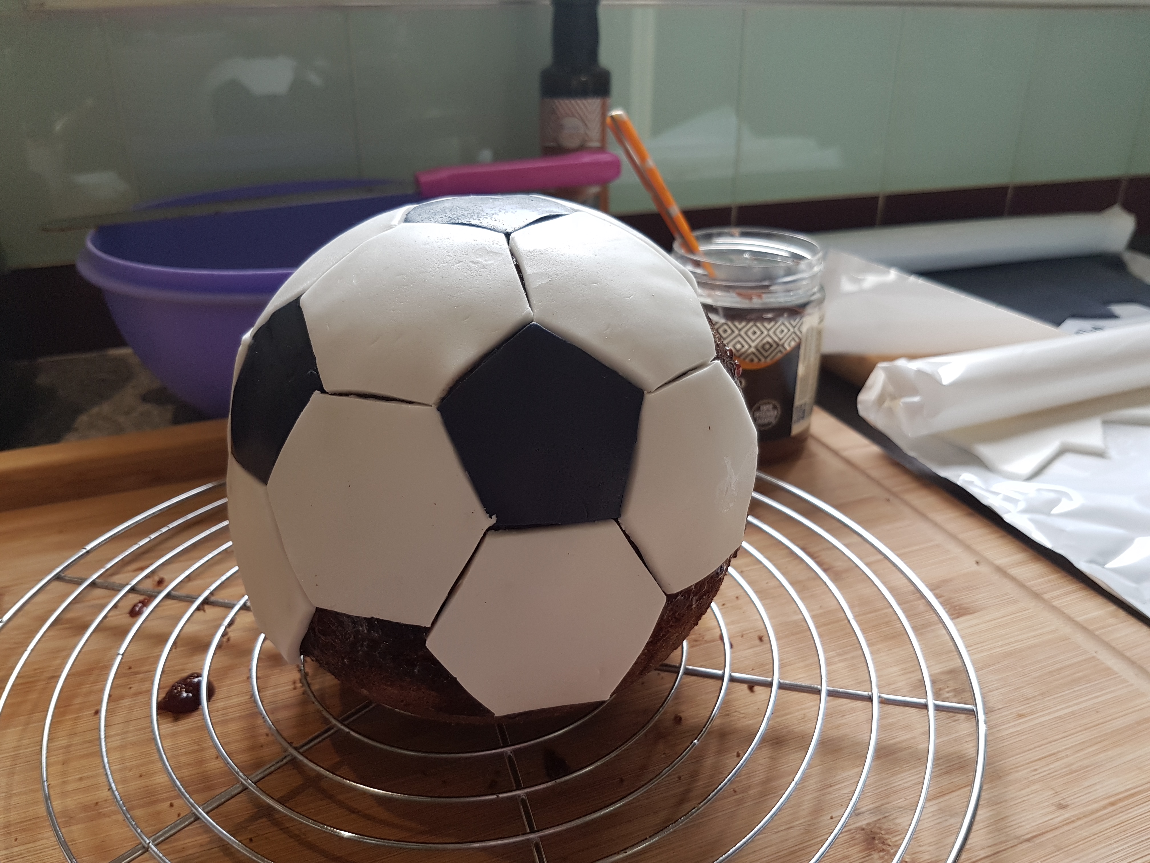 Gâteau ballon de foot à la caroube de Crète 2 Montage du gâteau ballon de foot : polygones de pâte à sucre posés sur le cake à la caroube